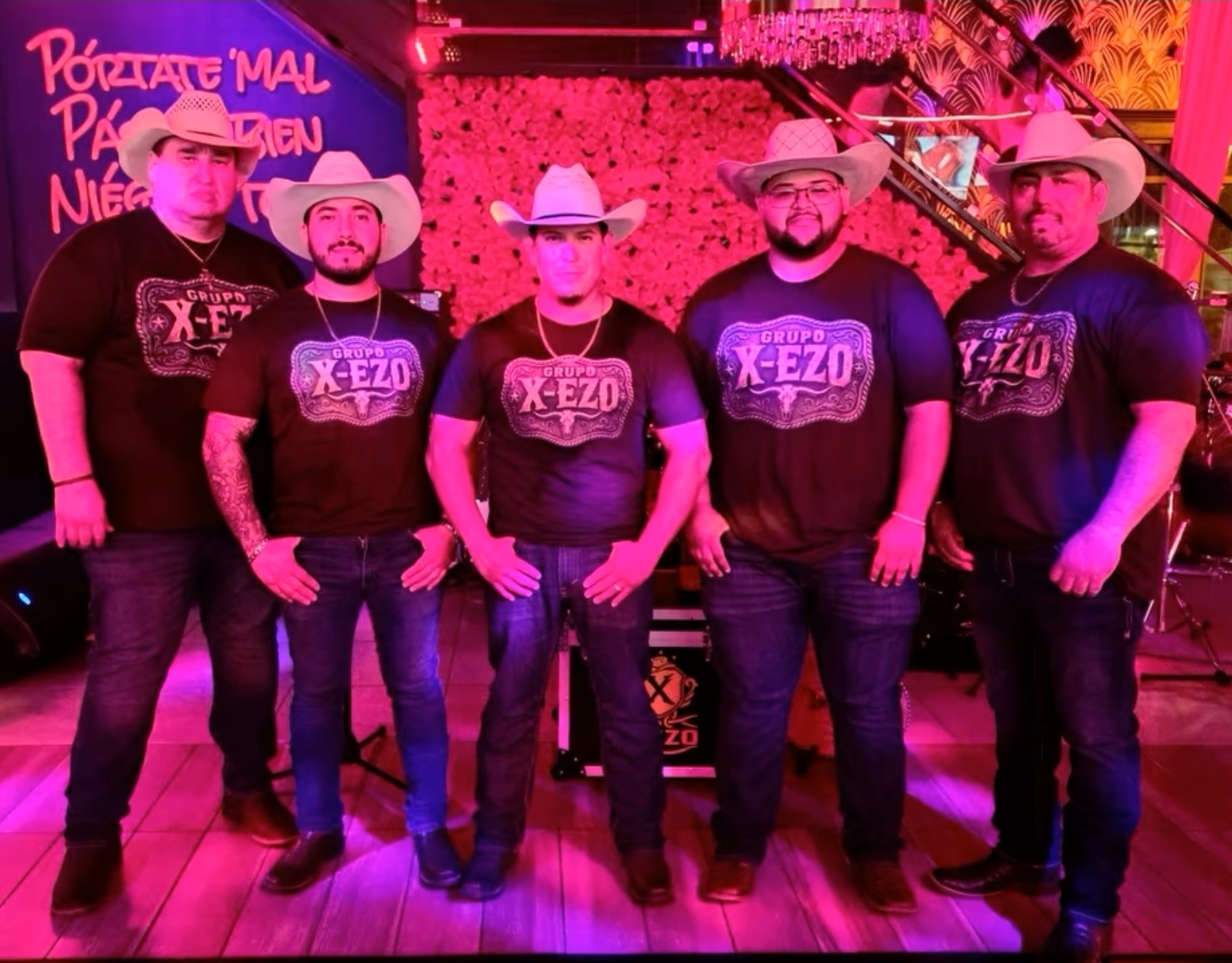 Grupo X-EZO band wearing custom X-EZO western belt buckle tees